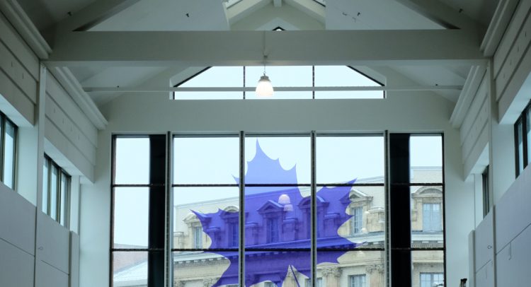 A window with a purple maple leaf logo