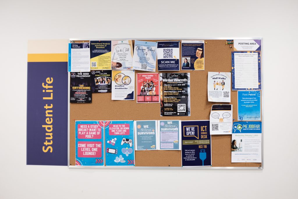 A corkboard with activities for students at Wilfrid Laurier University.