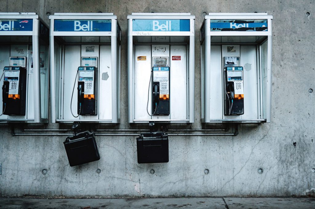 Row of Bell pay phones on a concrete wall